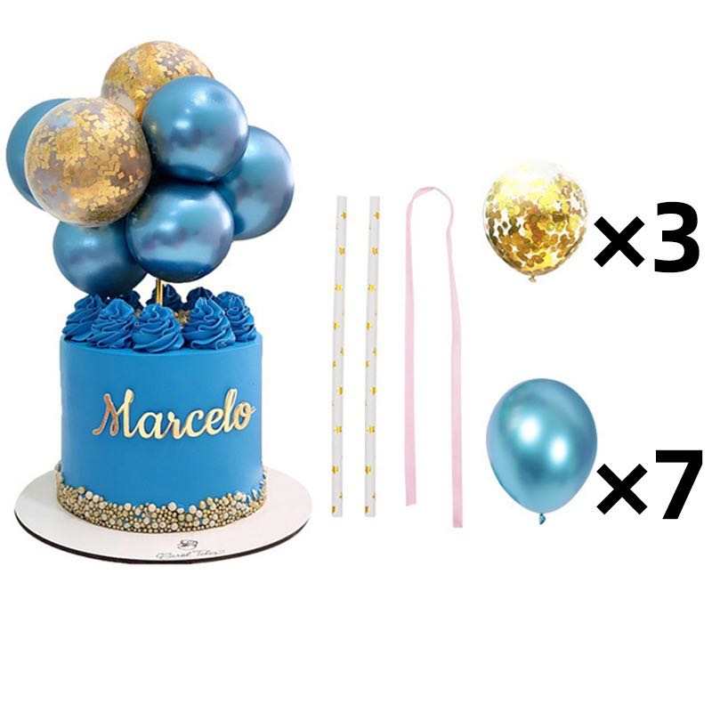 An image of a decorated cake featuring blue frosting and gold accents, topped with a cluster of balloons in various shades of blue and gold. The cake has the name "Marcelo" in golden letters. Next to the cake, there are three decorative straws, two pink ribbons, and a list indicating three confetti balloons and seven blue balloons included in the set. The overall theme suggests a festive celebration.