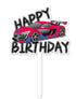 A vibrant cake topper featuring a stylized illustration of a red and blue sports car with the text "HAPPY BIRTHDAY" above it in bold, playful font. The topper includes a white stick for insertion into a cake.