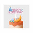 A colorful birthday cake adorned with a decorative topper. The topper features the phrase "HAPPY BIRTHDAY" in pink letters, along with a depiction of a character wearing a blue dress, a small seal, and a light orange crescent. The cake has a light beige base and is topped with orange frosting along with blue and green decorative elements.