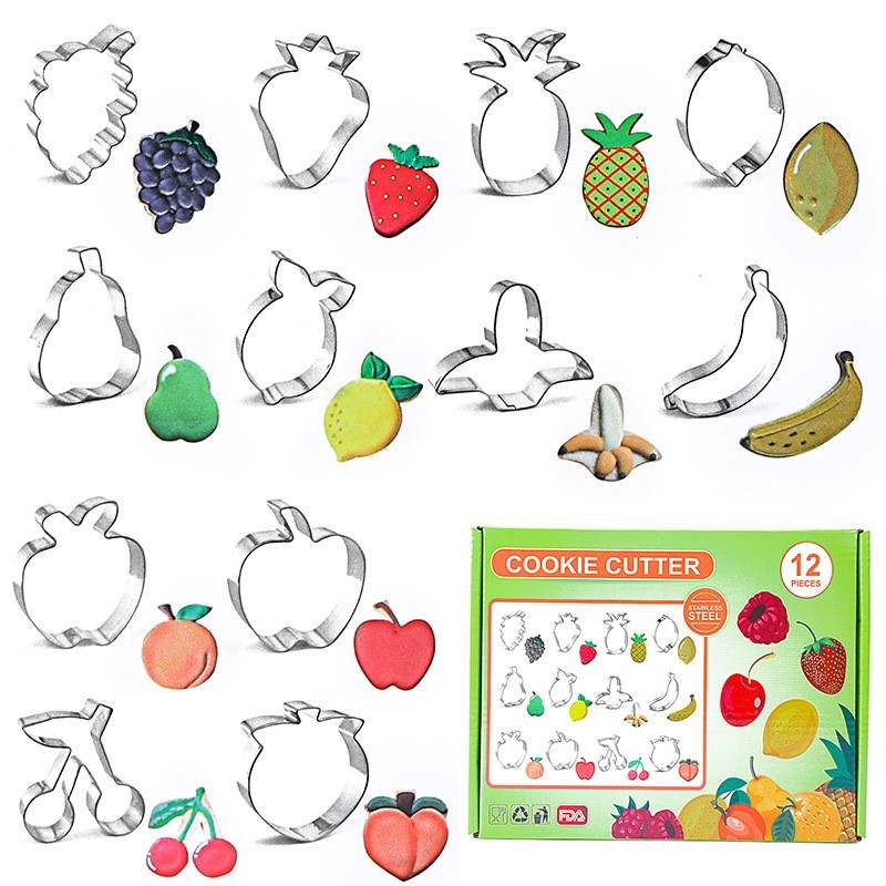 A collection of stainless steel cookie cutters shaped like various fruits, including a pineapple, strawberry, grape, pear, lemon, banana, apple, and cherry. Below each cutter, there are colorful, fruit-shaped cookies that match the cutter designs. The product packaging, labeled "COOKIE CUTTER" and indicating 12 pieces, is displayed at the bottom. The overall theme is vibrant and playful, emphasizing the fruit shapes of the cutters and the cookies.