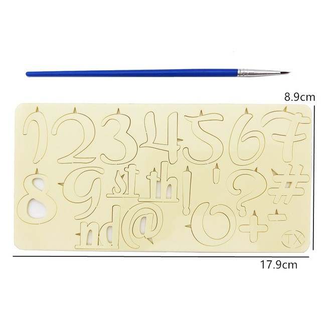 A beige acrylic stencil displaying various letters, numbers, and symbols, including "1-9," "g," "s," "t," "h," "nd," "@" and more. The stencil dimensions are approximately 17.9 cm in width and 8.9 cm in height. A thin blue paintbrush is positioned above the stencil. The design features cut-outs for easy stamping on cakes or other surfaces.