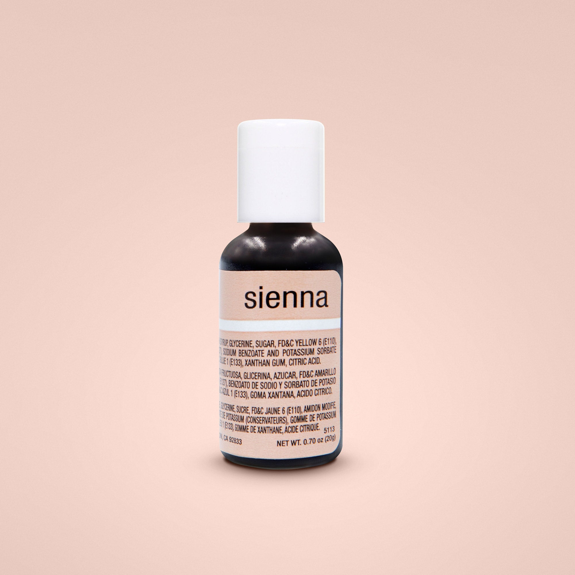 A small black bottle of Chefmaster Liqua Gel Color labeled "sienna." The bottle has a white cap and contains 0.7 oz (20 ml) of the product. The label includes ingredients and nutritional information, with some text in English and Spanish. The background is a soft, neutral peach color.