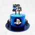 A two-tiered blue cake with a black base. The top is adorned with a black acrylic topper that reads "LEVEL 25th UNLOCKED" in bold letters, alongside a video game controller graphic. The cake features colorful shapes and a PlayStation logo on the front, with small black spikes around the base.
