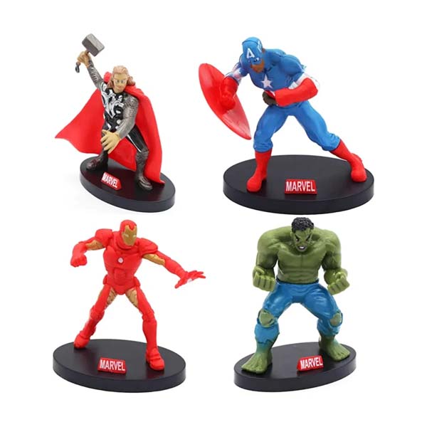 Four Marvel superhero cake toppers on black bases. The top left features a figure of Thor with a red cape and hammer. The top right shows Captain America with a blue costume and shield. The bottom left depicts Iron Man in red armor, and the bottom right is the Hulk in green, flexing his muscles. Each figure has a visible "Marvel" logo on the base.
