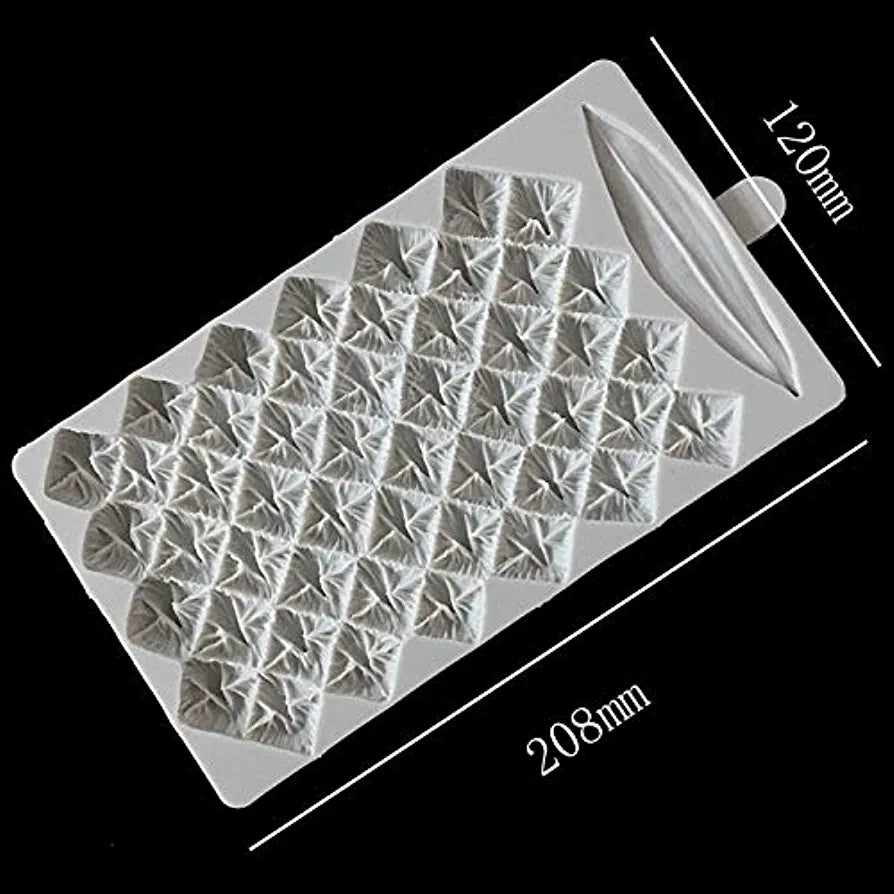 A pineapple-shaped silicone mold features a textured surface with multiple diamond-shaped impressions. The mold measures approximately 208mm in length and 120mm in width, with an elongated handle at one end for easy handling. The overall color of the mold is light gray against a black background.