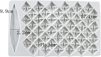 An overhead view of a white silicone mold designed to create pineapple-shaped decorations. The mold features multiple intricate patterns resembling pineapple scales, arranged in a grid layout. It includes measurements indicating the dimensions: 17.1 cm in length, 11.2 cm in width, and 9.9 cm in height, with an additional measurement of 2.2 cm for a separate elongated section on the left side. The overall design is both functional for baking or crafting and visually appealing.