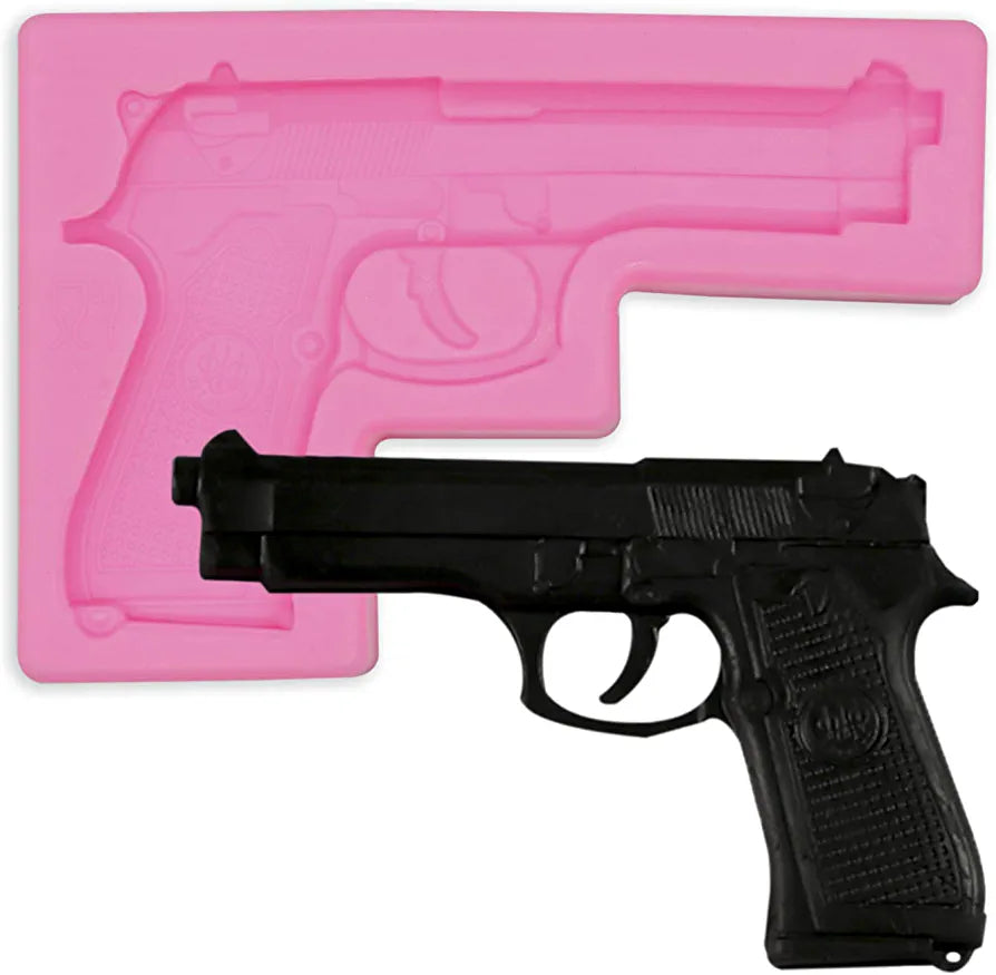 A pink silicone mold shaped like a pistol is displayed next to a black plastic model of a pistol. The mold features detailed engravings that replicate the design of the pistol, while the plastic model is positioned in front of it for comparison.