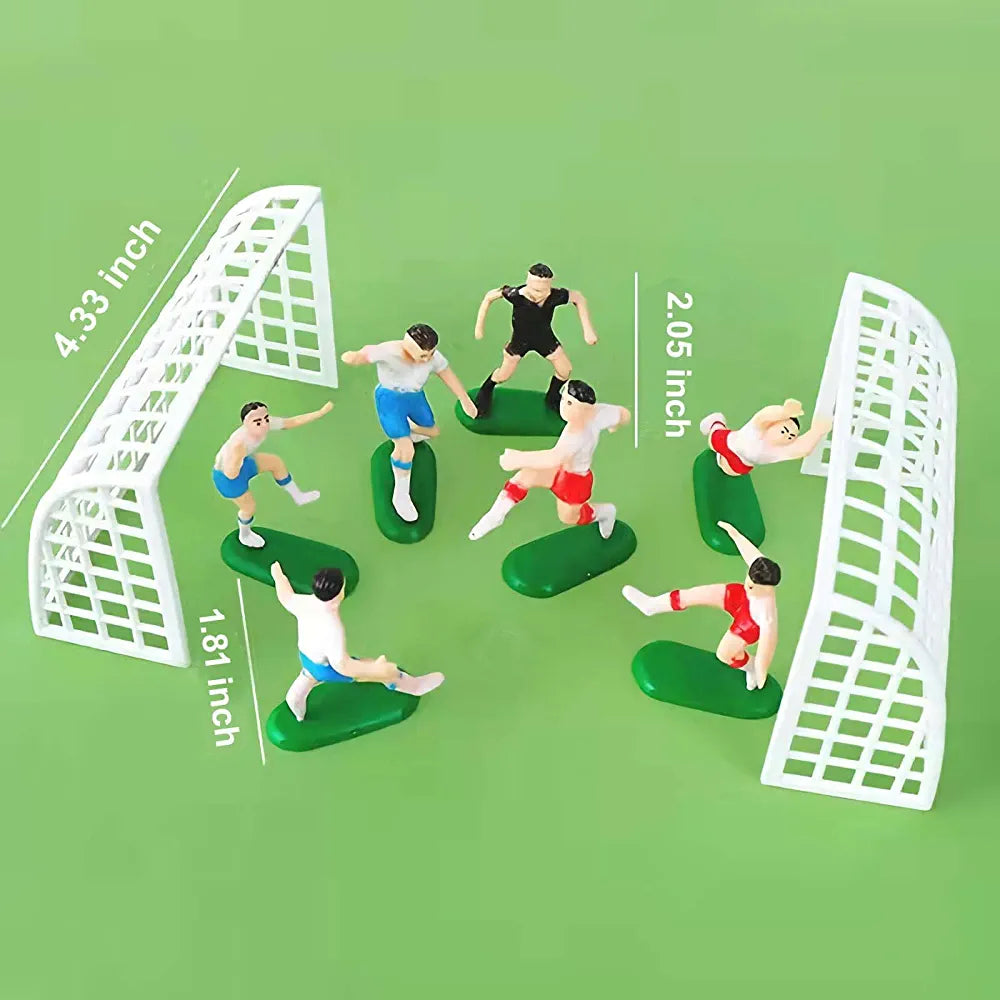 A soccer-themed cake topper set featuring six miniature soccer player figurines and two goalposts. The players are positioned on green bases, displaying different poses in a playful arrangement, while one is reaching for the goal. The goalposts are white with a grid design, standing at approximately 4.33 inches tall, and the players vary in height, with the tallest at about 2.05 inches and the shortest at 1.81 inches. The background is a solid light green color.