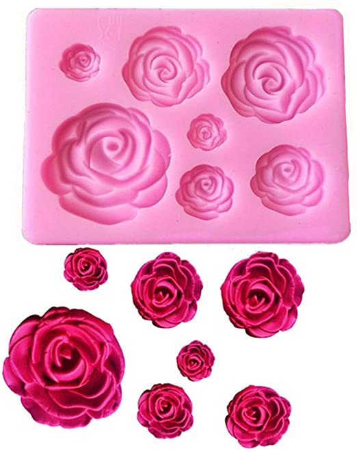 A pink silicone mould shaped like roses sits at the top of the image. The mould contains several rose designs in varying sizes, from small to large. Below the mould are several individual rose shapes, colored in shades of pink and red, showcasing their detailed craftsmanship.
