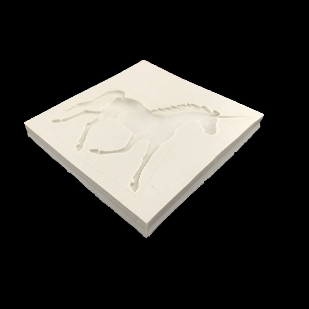 An angled view of a white silicone mold featuring a raised design of a unicorn in a leaping position. The mold is square with clean edges and a smooth surface, designed for creating 3D unicorn shapes in various crafting or baking projects. The background is black, highlighting the mold&