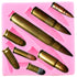 The image shows a pink silicone mould shaped like various bullets. The mould features several bullet forms of different sizes and shapes, with metallic finishes resembling brass. The bullets are positioned in various angles and arrangements within the mould, which is designed for creating bullet-shaped items, possibly for baking or crafting purposes.
