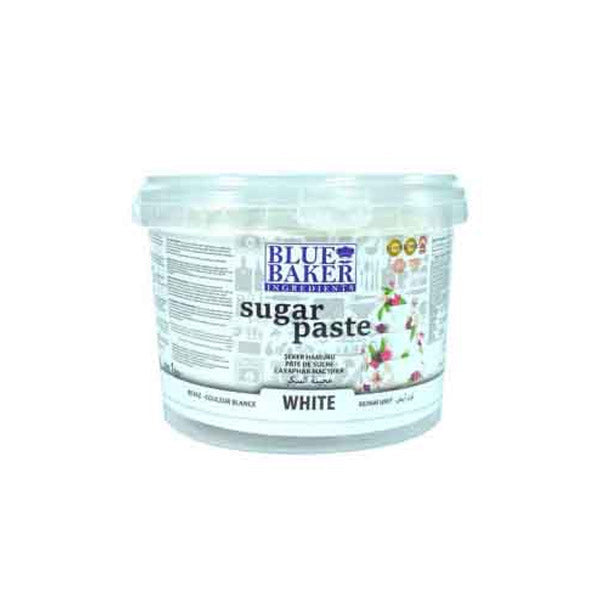 The image shows a plastic container of white sugar paste. The container has a clear lid and features a label with the brand name "BLUE BAKER" prominently displayed. The label also includes the words "sugar paste" and indicates that the product is white. Additional text likely provides details about the product, including instructions or ingredients. The background of the label features decorative floral designs, adding a colorful touch to the overall design.