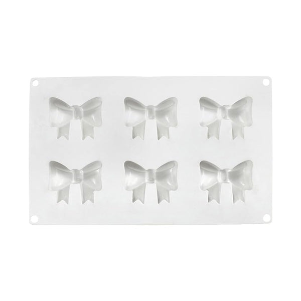A silicone mould featuring six bow-shaped cavities, arranged in two rows of three. The mould is white and flexible, with each bow design including a central knot and flowing tails.