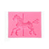 A pink silicone mould shaped like a carousel horse, featuring intricate detailing of the horse and a central post. The horse is in a dynamic pose, with decorative elements visible on its body and a flowing mane.