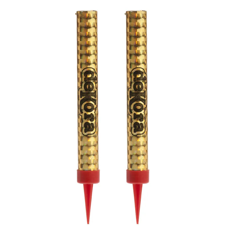 Two gold sparkler candles with a textured surface and the brand name "dekora" printed in black, topped with red tips, standing upright against a white background.