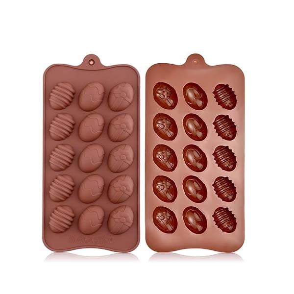 The image features a silicone mold designed for creating egg-shaped treats. The mold is divided into two sections, each containing multiple cavities. The left section has eight cavities shaped like decorated eggs with various patterns, while the right section contains seven additional egg-shaped cavities with different designs. The mold is brown in color and has a convenient hanging tab at the top for easy storage.