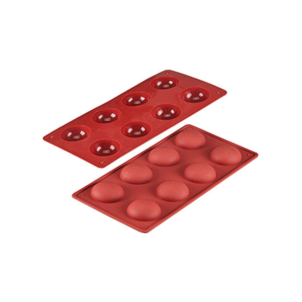 Two red silicone chocolate molds are displayed, each featuring eight cavities in a half-sphere shape. One mold is positioned above the other, with the top mold having rounded projections and the bottom mold having corresponding depressions. The molds are designed for creating half-sphere chocolate treats.