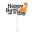 A colorful birthday cake topper featuring the text "Happy Birthday" in bold letters. The word "Happy" is in black, while "Birthday" is in gray. An orange dinosaur character is positioned to the right, with small rocks and green grass illustrations below the text. The topper has a white stick for placement in a cake.