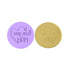 The image features two circular cookie stamps designed for embossing fondant. On the left, a lavender-colored stamp has the text "I love you MOM" inside a heart, with decorative flowers. On the right, a gold-colored stamp displays a similar message with the phrase "I love you MOM" also enclosed in a heart shape. Both stamps are shown side by side against a white background.