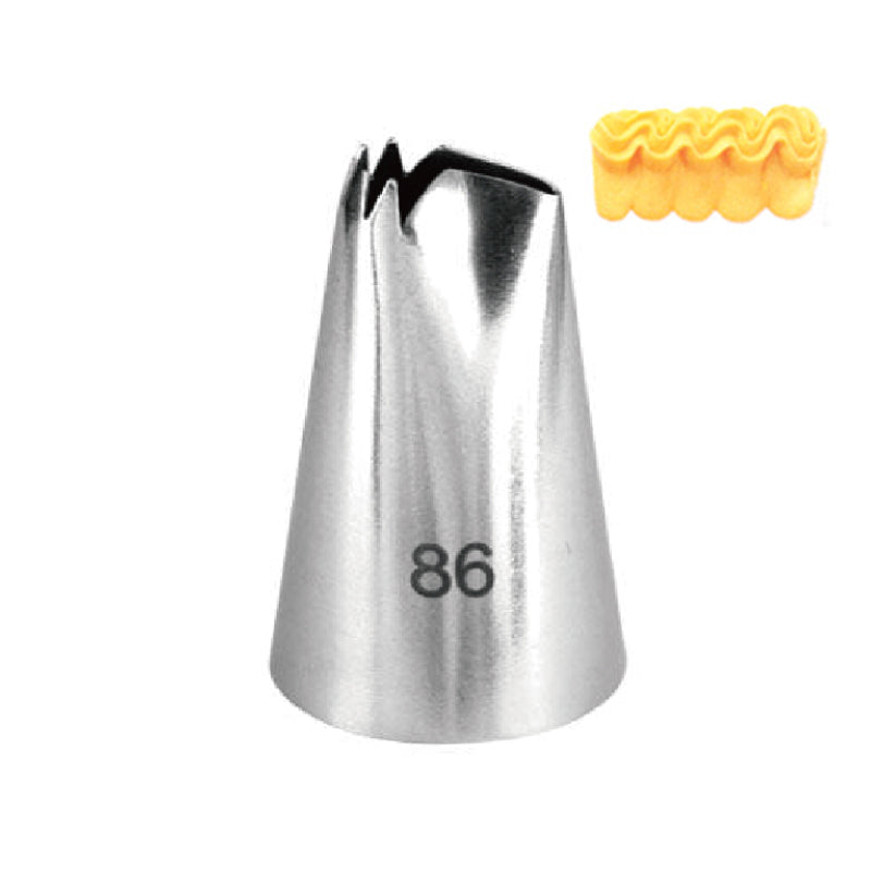 A metallic piping nozzle labeled "86" with a pointed tip and decorative ridges at the opening, positioned next to a small, wavy piece of yellow frosting.