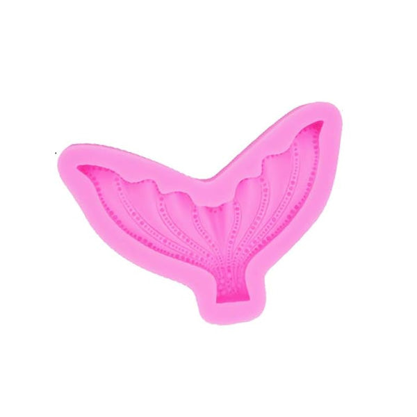 A pink silicone mold in the shape of a mermaid tail, featuring intricate detailing on the fins and body. The mold is designed for baking or crafting purposes.