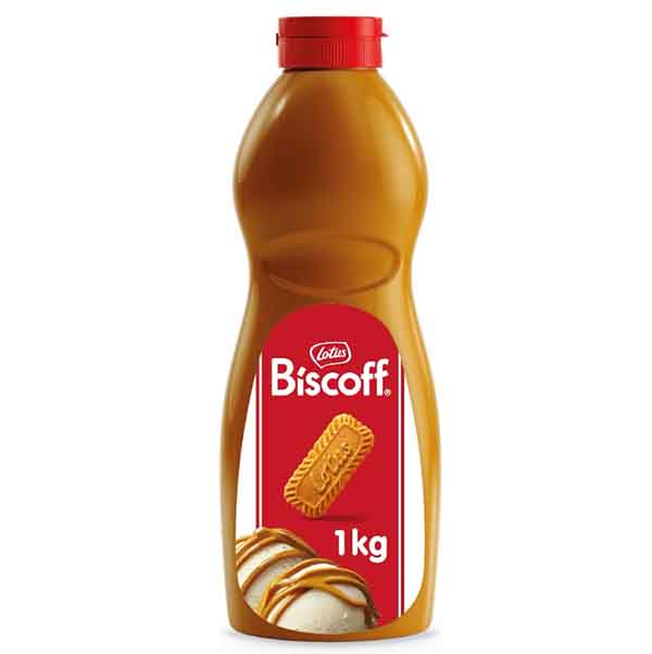 A bottle of Lotus Biscoff topping, labeled with "Biscoff" and "1 kg." The bottle has a red cap and a design featuring a Biscoff cookie illustration, with a drizzle of the topping over ice cream. The overall color scheme includes brown and red.