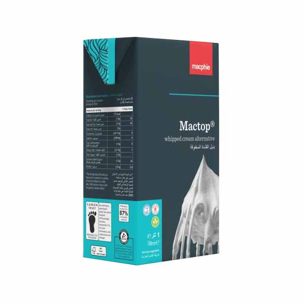 A carton of Mactop whipped cream alternative is displayed, featuring a dark blue and green design. The front of the carton prominently showcases the product name, "Mactop," alongside the phrase "whipped cream alternative" in both English and Arabic. The side of the carton lists nutritional information and product details, while the bottom includes various certifications and environmental information. The carton has a distinctive design with a splash image of whipped cream at the top.