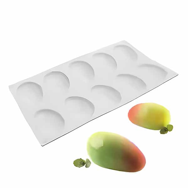 A silicone cake mold shaped like mangoes, containing eight rounded cavities. Two finished mango-shaped cakes are placed beside the mold, showcasing a gradient of green and yellow colors with a small green leaf attached. The mold is flexible and white in color.