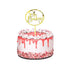 A decorated cake featuring a shiny gold acrylic topper that reads "Oh Baby!" The cake has a white base with pink icing drips and is topped with whipped cream and sprinkles. The sides of the cake are adorned with colorful sprinkles, creating a festive appearance.