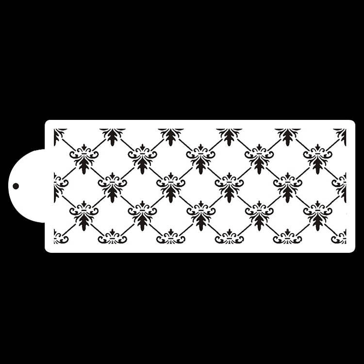 A white cake stencil featuring a detailed black floral and diamond pattern. The stencil has a rounded cutout at one end for easy handling. The design consists of symmetrical elements arranged in a repeating pattern.