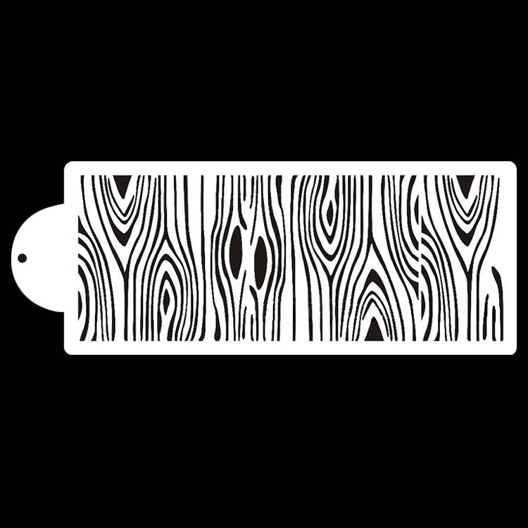 The image features a white cake stencil shaped like a long rectangular strip with rounded ends. The stencil displays a decorative pattern resembling wood grain, with alternating lines and shapes that mimic the texture and appearance of tree bark. The background is black, contrasting with the white stencil.