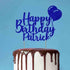 A birthday cake with a glossy chocolate drip on the edges. Topped with a glittery blue cake topper that reads "Happy Birthday Patrick," accompanied by a blue balloon graphic, against a light blue background.