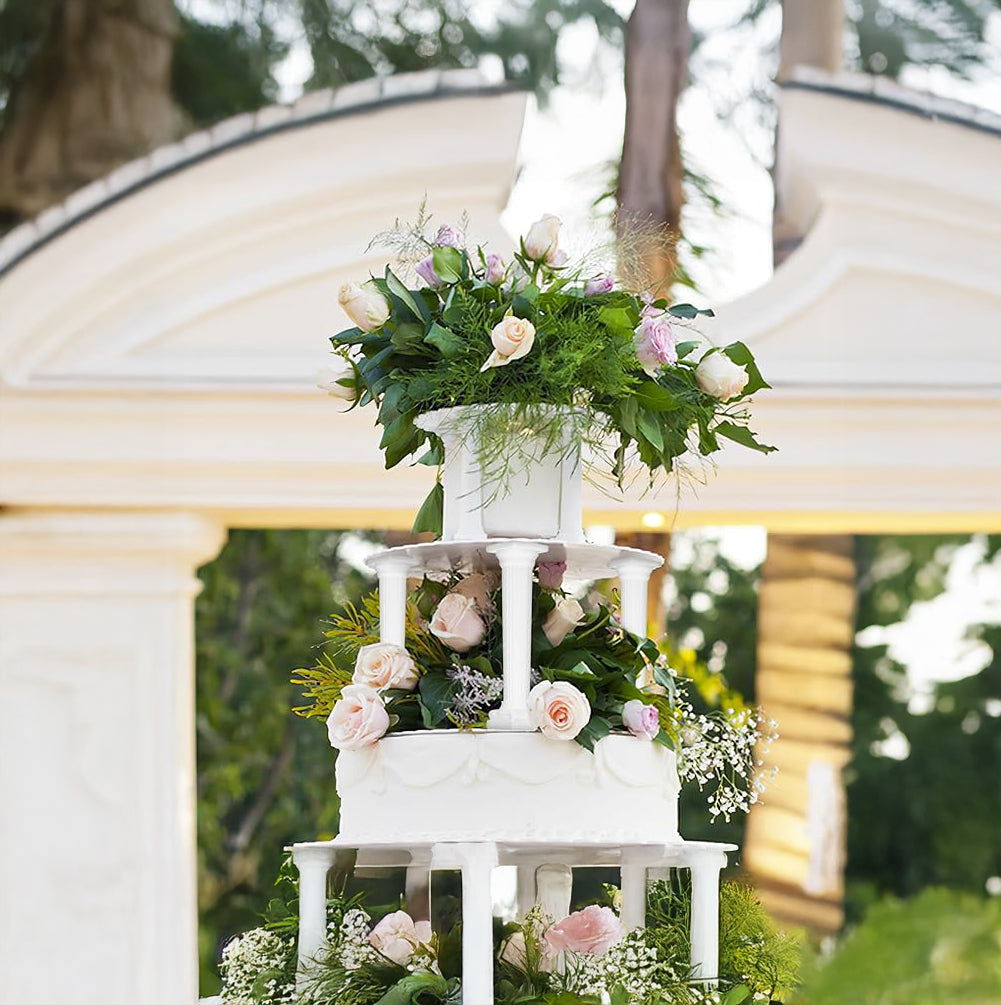 An elegant wedding cake with multiple layers, topped with vibrant flowers, showcasing a classic and festive design.