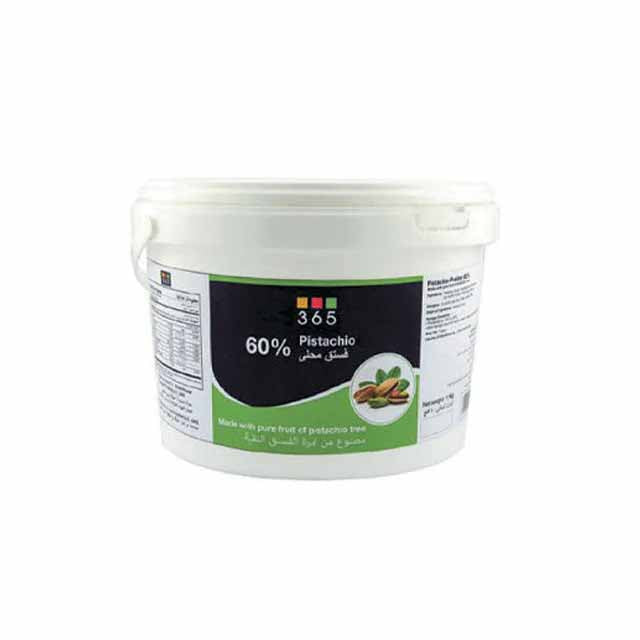 A white plastic container labeled "365 60% Pistachio." The label features a green section with images of pistachio nuts and includes text indicating it is made with pure fruit from the pistachio tree. The container has a handle and nutritional information on the side.