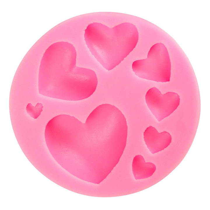A round, pink silicone mould featuring various sizes of heart shapes. The mould has a total of six heart cavities, ranging from small to large. The design is playful and is ideal for creating heart-shaped confections or crafts.