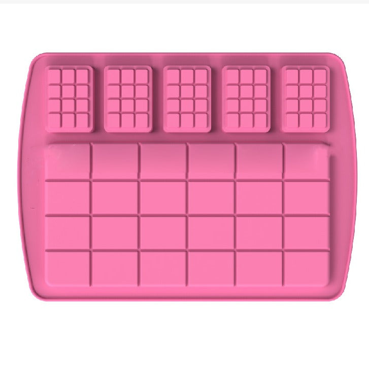 A pink silicone mold designed for making chocolate bars. The mold features several cavities, including a large rectangular section with multiple smaller square compartments at the bottom and three smaller rectangular compartments at the top. The overall design allows for the creation of both large and mini chocolate bars.