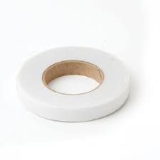 A roll of white florist tape resting on a plain background, featuring a cardboard core in the center.
