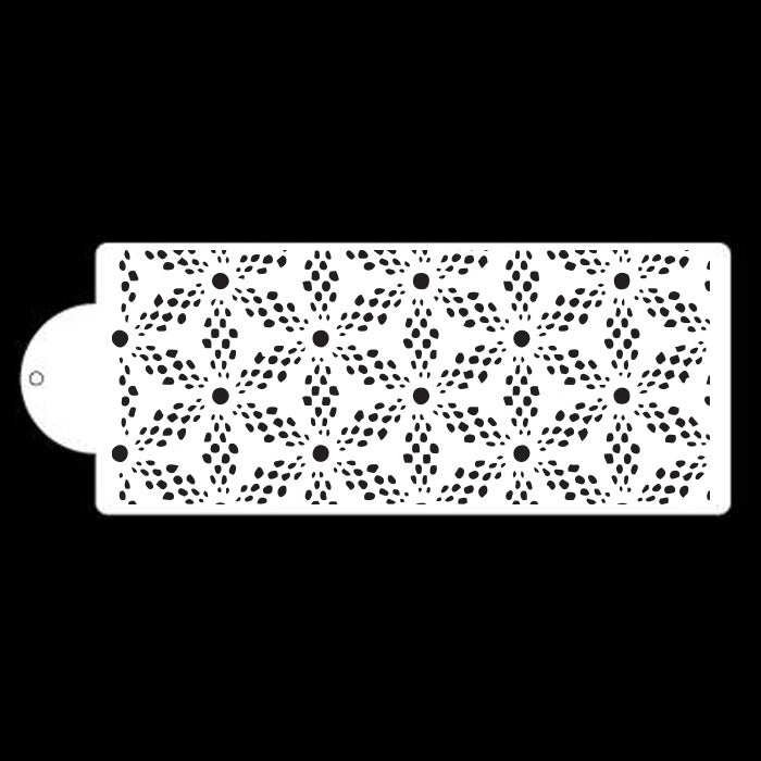 A rectangular cake stencil featuring a repetitive floral pattern. The design consists of star-like flowers with rounded petals, surrounded by small circular dots. The stencil is white with cut-out designs, allowing for the application of icing or dusting on cakes. One end of the stencil has a rounded tab for easy handling. The background is black, highlighting the stencil&
