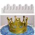 The image shows two items related to cake decoration. The top part features a white silicone mold shaped like a crown, with decorative peaks and grooves. The bottom part displays a golden crown made of fondant, placed on a cake with a blue, sparkly surface and white icing accents. The crown has several round balls and pointed peaks, enhancing its regal appearance.