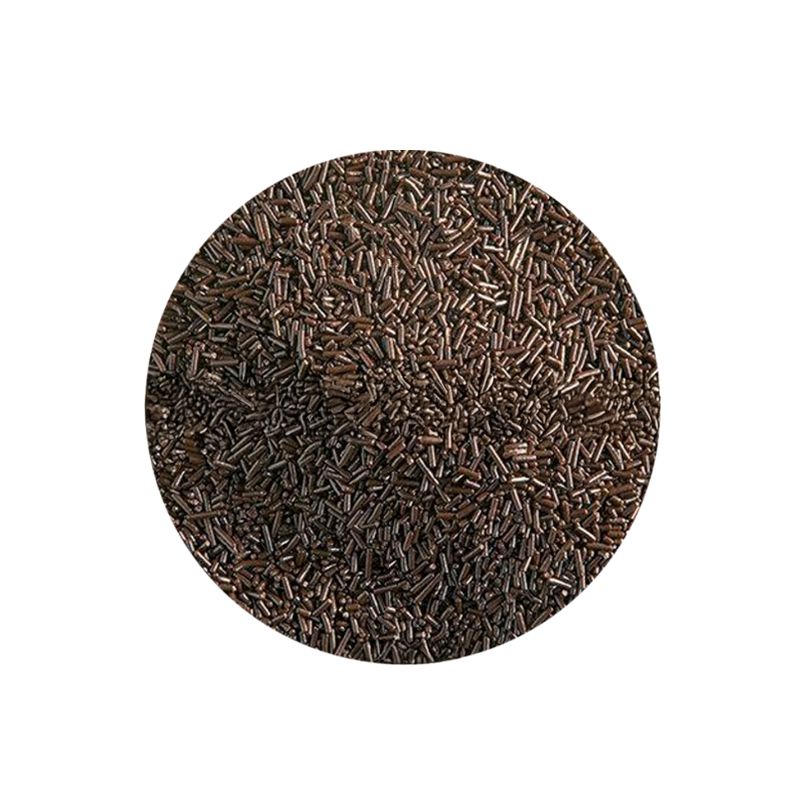 A circular pile of brown sprinkles against a white background. The sprinkles are uniformly shaped and densely packed, conveying a sense of texture.