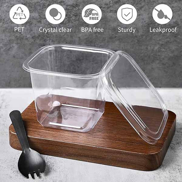 A square, clear plastic dessert cup with a lid is placed on a wooden surface. Next to it is a black plastic spoon. Above the cup, there are icons indicating features such as PET material, crystal clarity, BPA-free, sturdiness, and leakproof design.