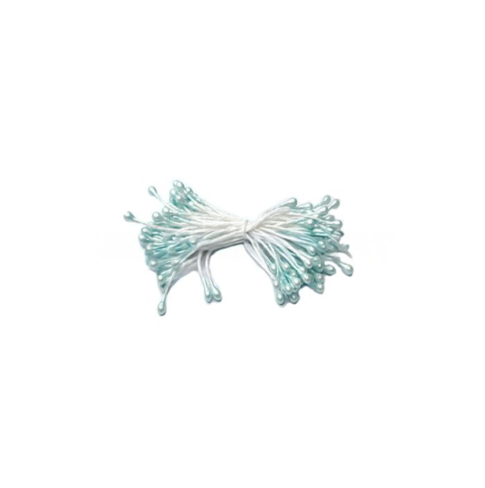 A bundle of light blue cake stamens with white stems, forming a bow shape against a plain white background, conveying a sense of delicacy.