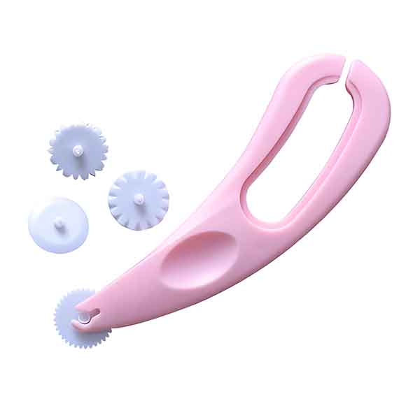 A pink fondant cutter embosser tool with a handle and a circular cutting wheel. Next to it are three interchangeable white cutting wheels of varying designs, including a scalloped wheel, a straight wheel, and a small circular wheel. The tool and wheels are designed for creating decorative patterns in fondant or other soft materials.