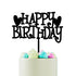 A black acrylic cake topper that reads "HAPPY BIRTHDAY" with heart shapes above the words, sitting on top of a cake with pastel-colored swirl icing in shades of mint green, pink, and white. The cake has a smooth, light-colored surface.