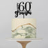 A round cake decorated with a smooth white icing. The bottom half features a marbled design with shades of green and a gold stripe. On top of the cake, there is a black acrylic cake topper that reads "HAPPY 60th grandpa." The cake is placed on a simple white cake stand. The background is a plain light color.