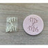 A pink fondant cookie stamp and a small clear plastic stamp. The pink stamp features the words "Mr & Mrs" in a script font, and the clear stamp contains the same words "&" in a smaller design. Both stamps are displayed on a light wooden surface.