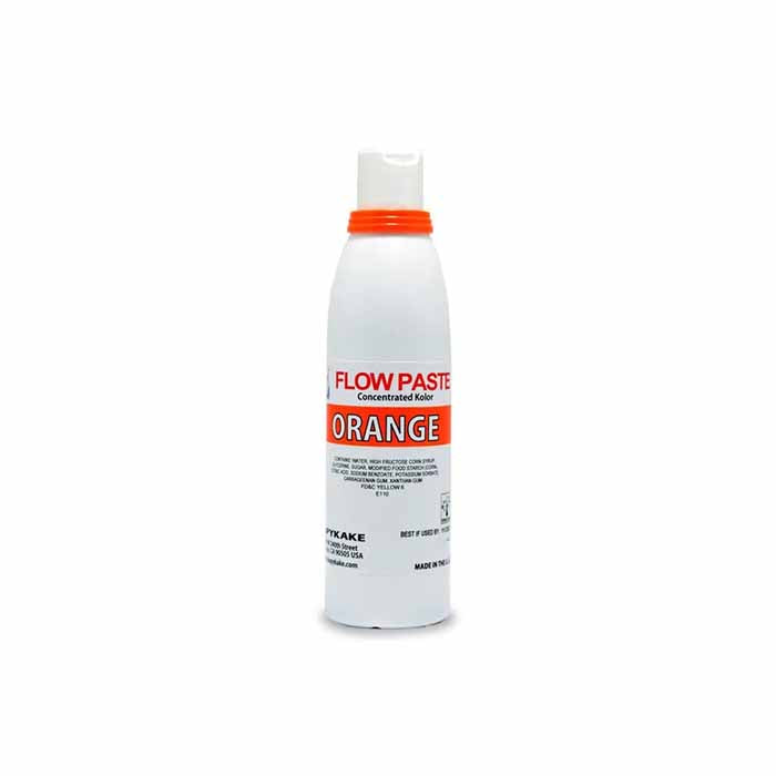 A white bottle of Kopykake Flow Paste in orange color. The bottle features an orange cap and a bold label with "FLOW PASTE" and "ORANGE" printed in red and orange text. The label provides information about the product, including that it is a concentrated color used in baking and decorating.