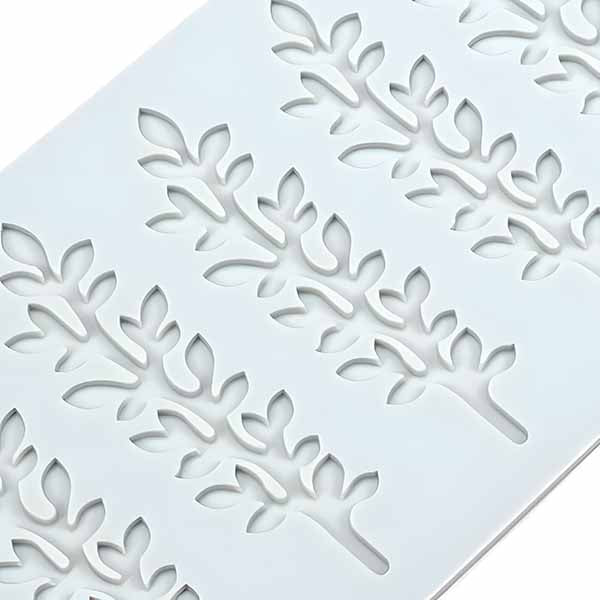 A close-up view of a silicone mold featuring detailed leaf stem designs, showcasing intricate patterns for creating edible or decorative items.