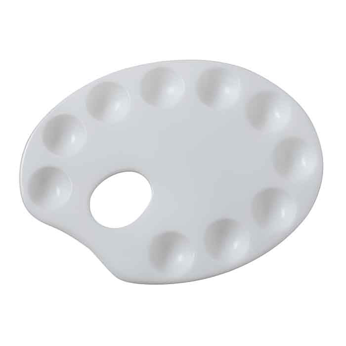 A white icing colour mixing palette, shaped like an artist&