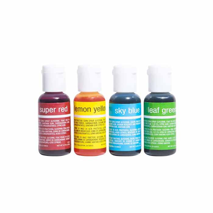 A set of four bottles of food coloring, labeled from left to right: "super red," "lemon yellow," "sky blue," and "leaf green." Each bottle has a white cap and features vibrant colors corresponding to the labels. The bottles are arranged closely together on a light background.